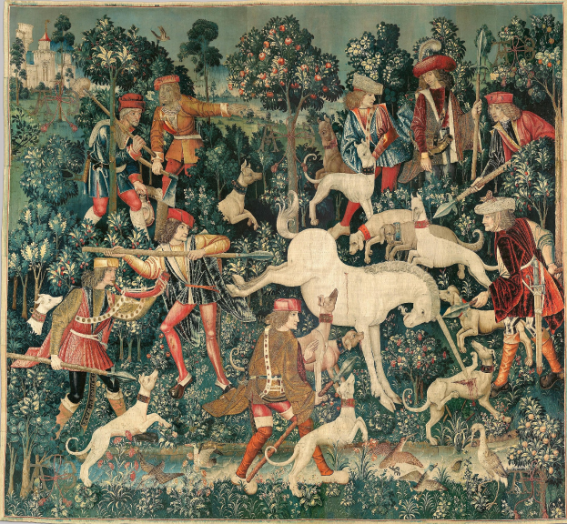Ein mittelalterliches Wandteppichbild, das eine Jagdszenen mit Menschen in historischer Kleidung, Tieren, Bäumen, Pflanzen, Blumen, Vögeln und einer Burg im Hintergrund zeigt.