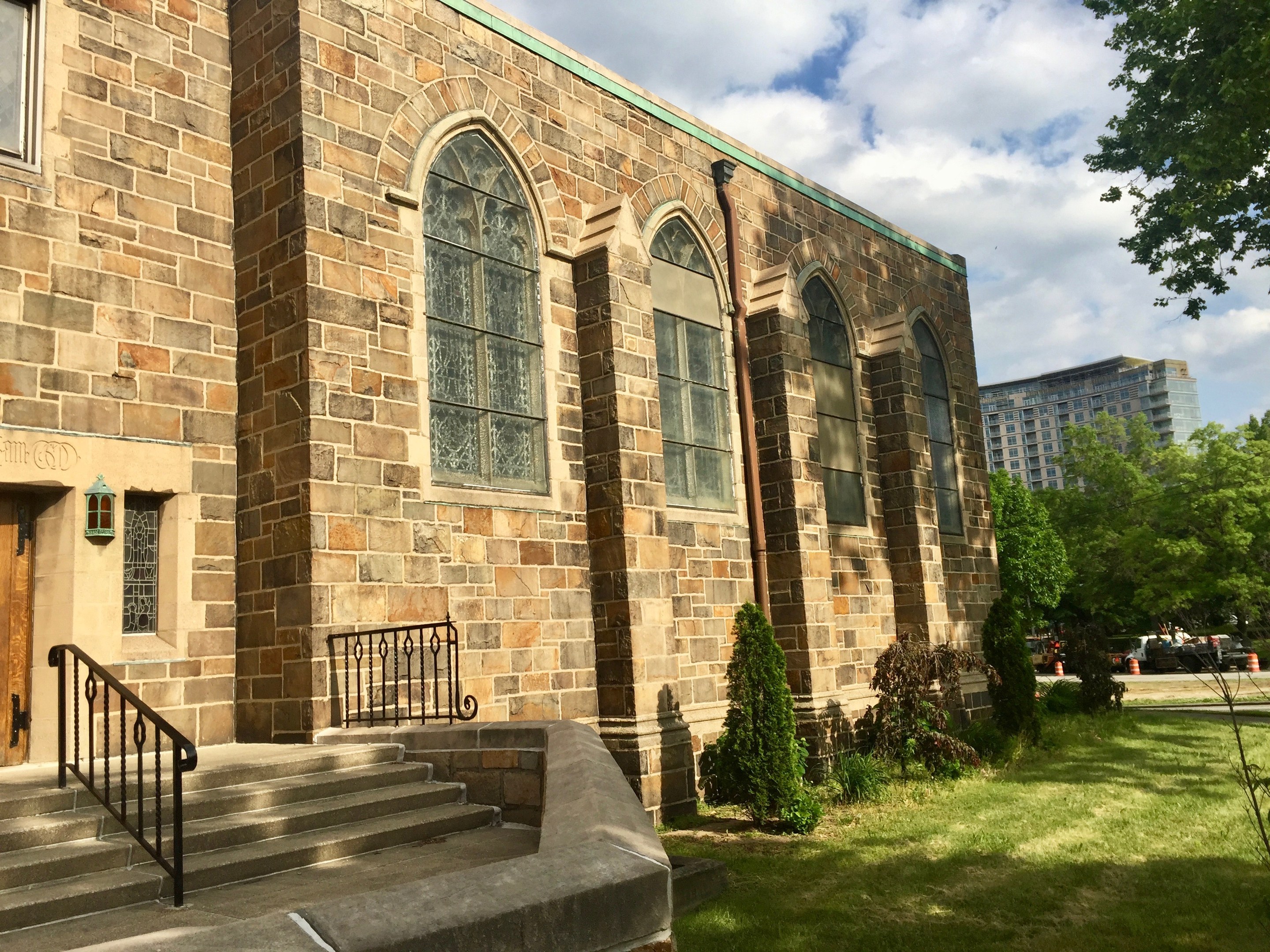 Großer steinerner Kirchenbau mit grüner Dachfläche, Treppe und umgebender Vegetation, als St. Mary's Episcopal Church nach Renovierungen identifiziert.