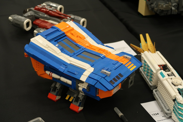 Ein Tisch voller verschiedener Lego-Spielzeuge, darunter ein Stift, Papier und andere Gegenst├Ąnde.